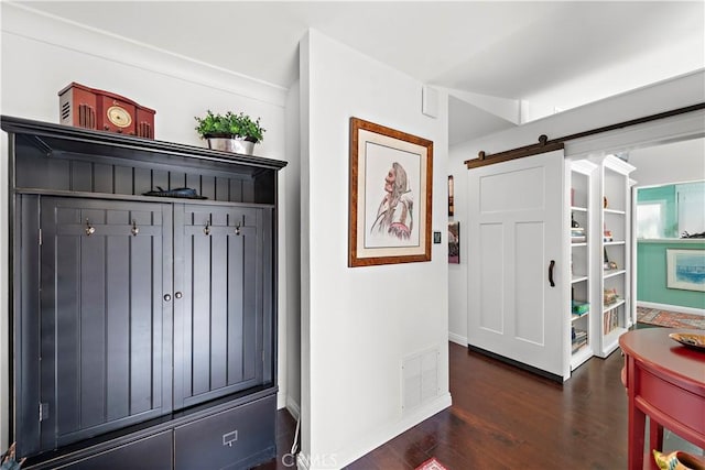 interior space with dark hardwood / wood-style flooring and a barn door