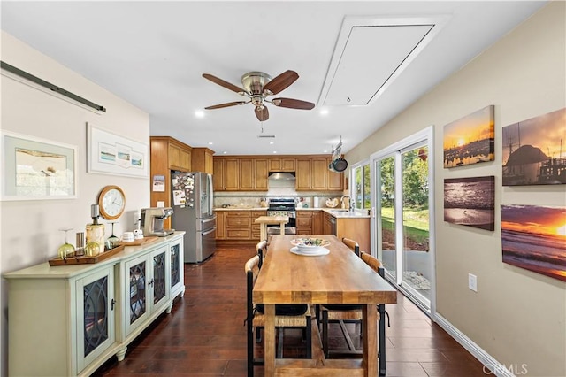 dining room featuring ceiling fan, sink, and dark hardwood / wood-style flooring