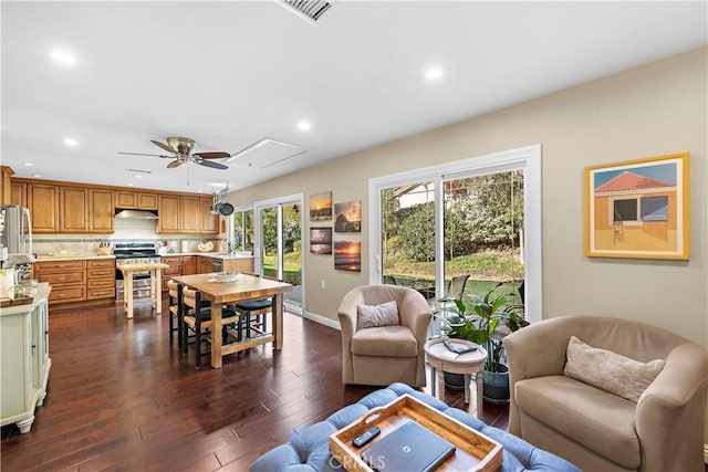 living room with dark wood-type flooring, ceiling fan, and sink