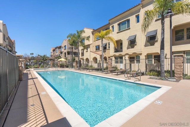 view of pool with an AC wall unit