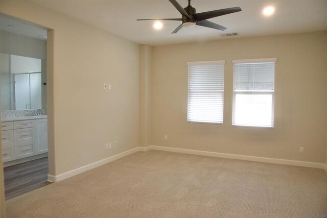 spare room featuring ceiling fan and carpet flooring