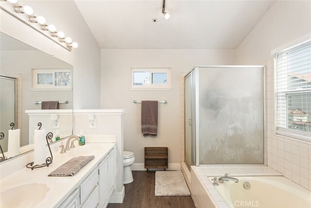 full bathroom featuring toilet, vanity, wood-type flooring, and plus walk in shower