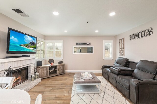 living room with a fireplace and light hardwood / wood-style floors