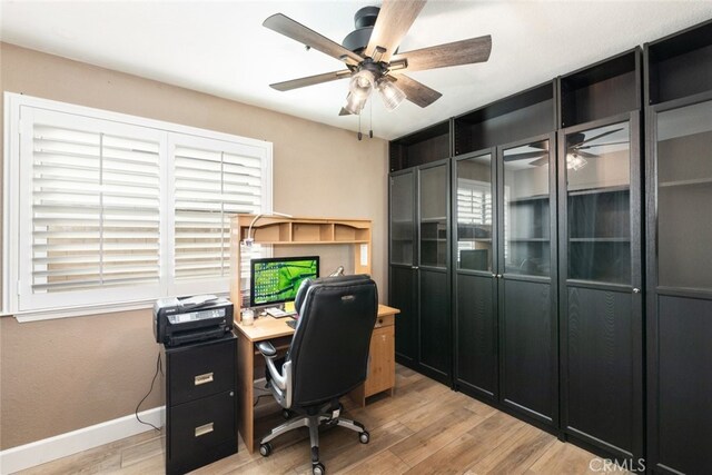 office featuring light hardwood / wood-style floors, a wealth of natural light, and ceiling fan