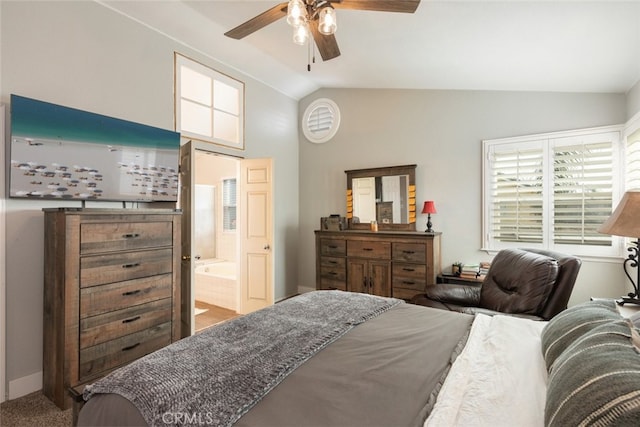 carpeted bedroom with ceiling fan, ensuite bathroom, and lofted ceiling