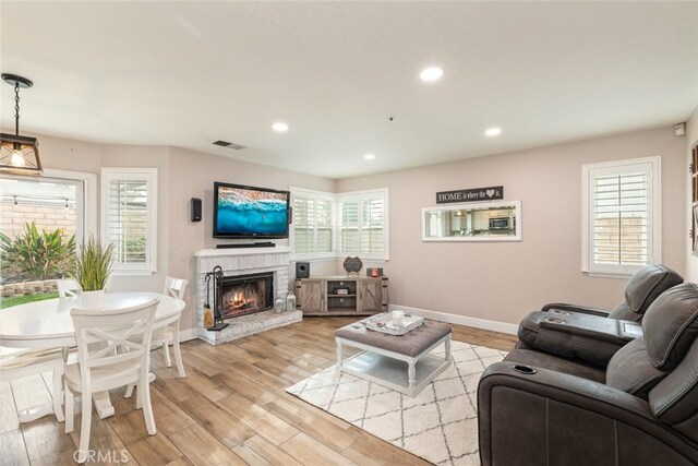 living room featuring plenty of natural light and light hardwood / wood-style flooring