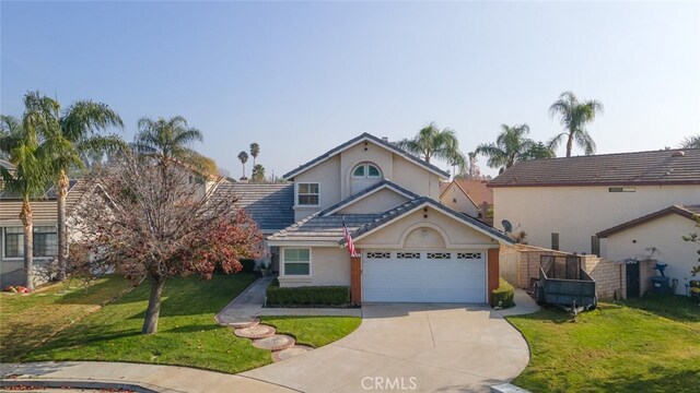 view of property with a front lawn and a garage