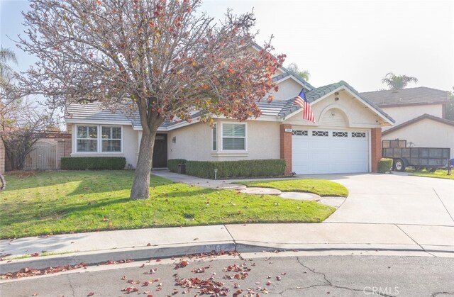 view of front of home with a front lawn and a garage