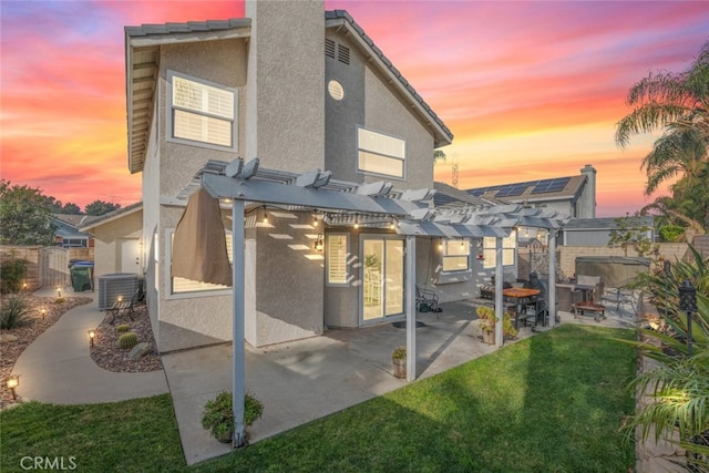 back house at dusk featuring a pergola, cooling unit, a lawn, and a patio