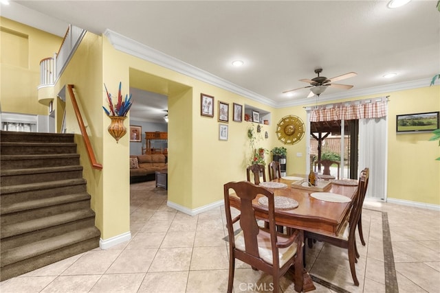 dining space featuring ceiling fan, light tile patterned flooring, and crown molding