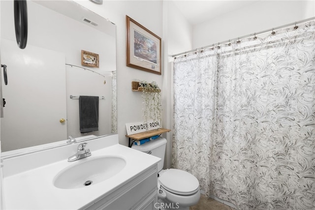 bathroom featuring toilet and vanity