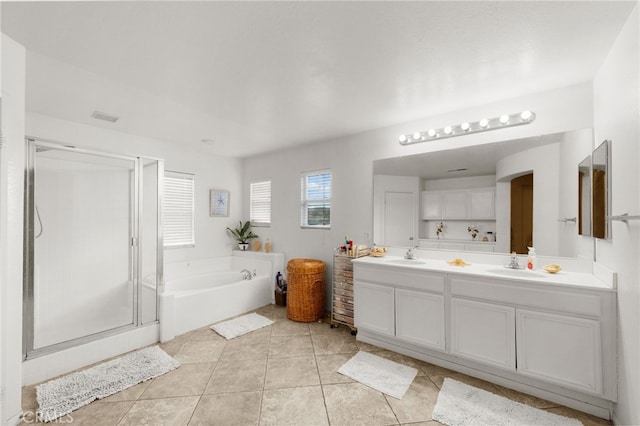 bathroom featuring plus walk in shower, tile patterned flooring, and vanity