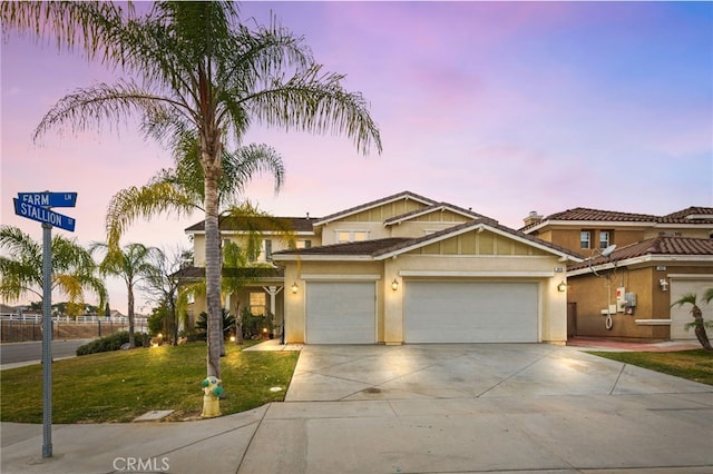 view of front of home featuring a garage and a lawn