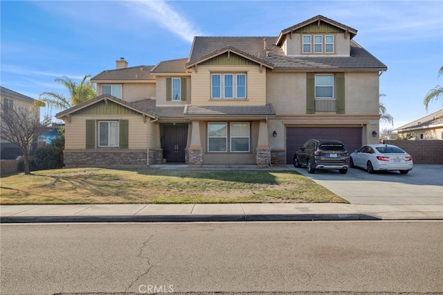 craftsman-style home featuring a front lawn and a garage