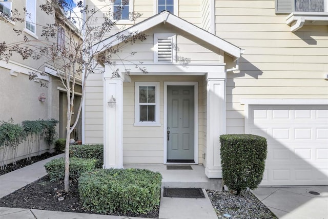 view of exterior entry with a garage