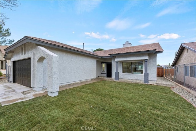 view of front of house featuring a garage and a front lawn