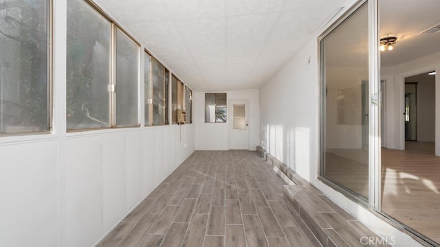 hallway with hardwood / wood-style flooring