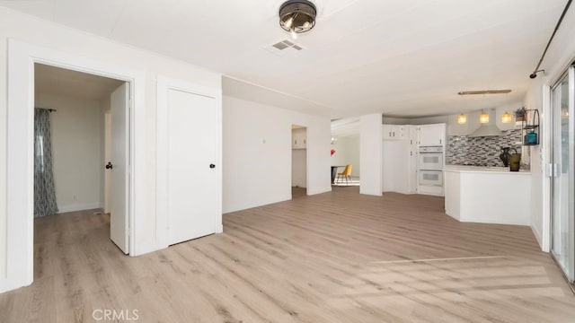 unfurnished living room with light hardwood / wood-style flooring