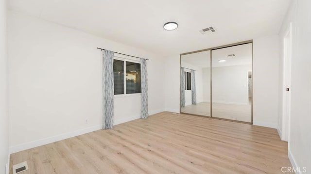 spare room featuring light hardwood / wood-style flooring