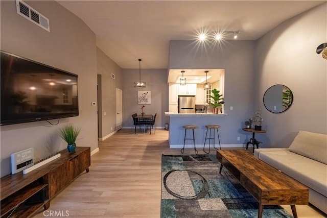 living room featuring light hardwood / wood-style floors and track lighting