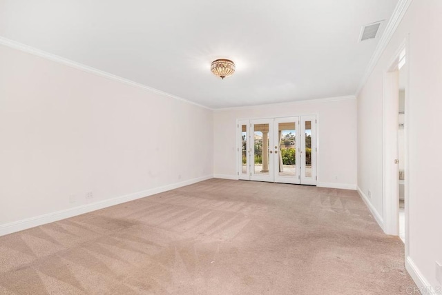 empty room with light colored carpet, crown molding, and french doors