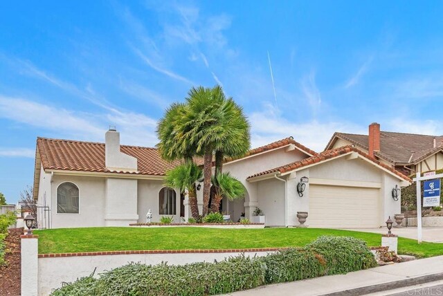 view of front of house with a front yard and a garage