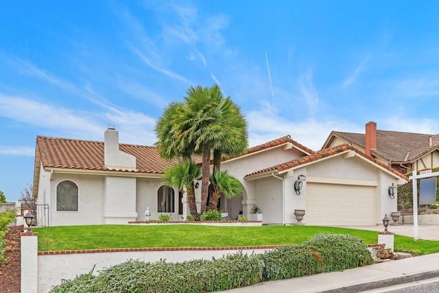 view of front of property featuring a front yard and a garage