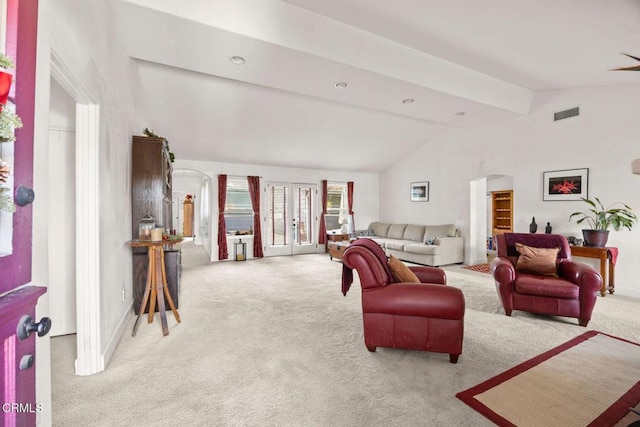 living room featuring light carpet, french doors, and vaulted ceiling