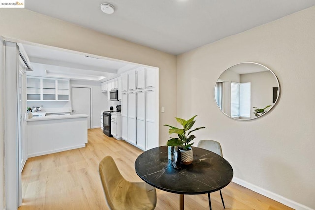 dining area with light wood-type flooring