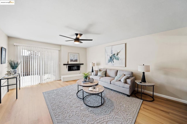 living room featuring ceiling fan and wood-type flooring