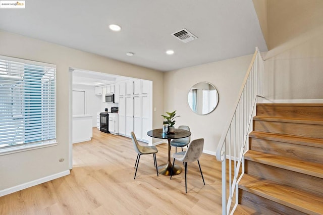 dining room featuring a healthy amount of sunlight and light hardwood / wood-style floors