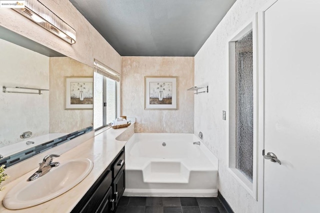 bathroom featuring a washtub and vanity