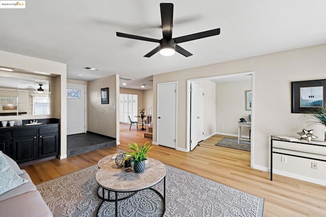 living room with ceiling fan, plenty of natural light, and hardwood / wood-style floors