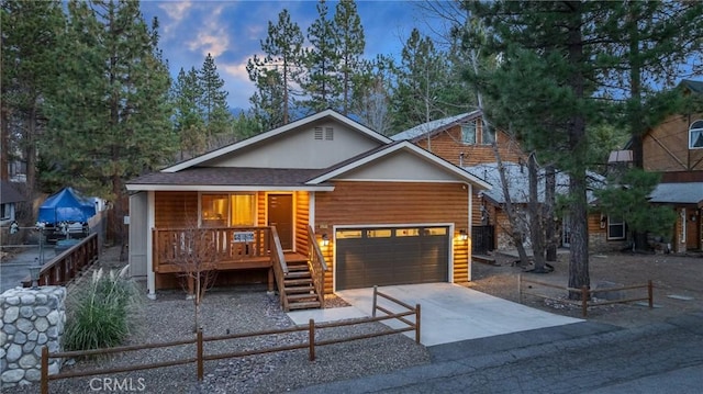 view of front facade featuring a porch and a garage