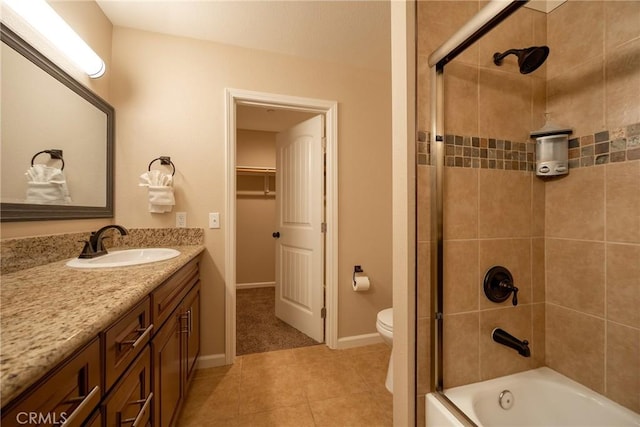 full bathroom featuring toilet, tiled shower / bath combo, tile patterned floors, and vanity