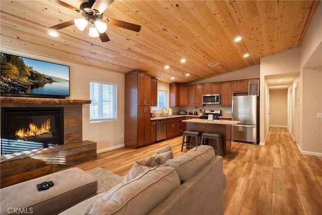 living room with light hardwood / wood-style flooring, vaulted ceiling, sink, and wooden ceiling