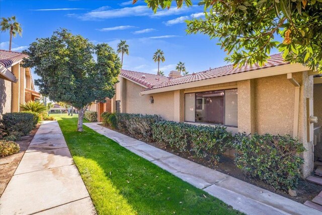 view of property exterior with a lawn