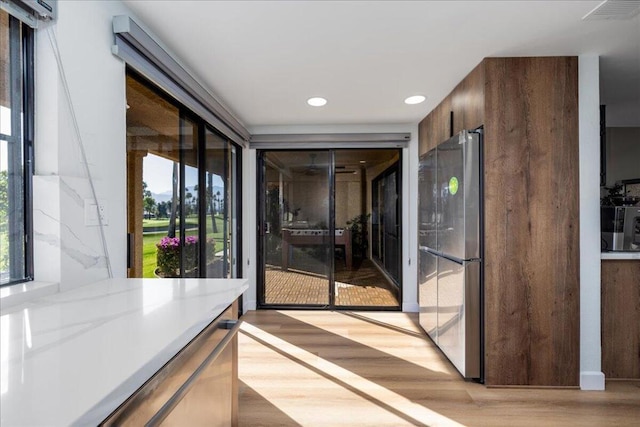 hall with light hardwood / wood-style floors