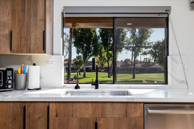 kitchen featuring stainless steel dishwasher, decorative backsplash, refrigerator, and light stone counters