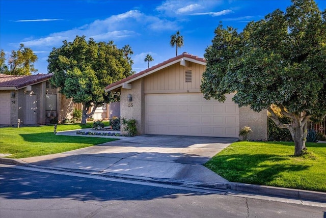 view of front of property with a front lawn and a garage