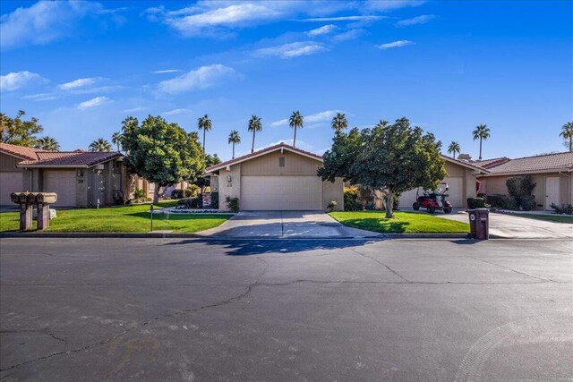 ranch-style house with a front lawn and a garage