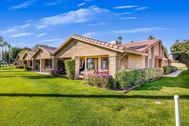 back of house with a lawn