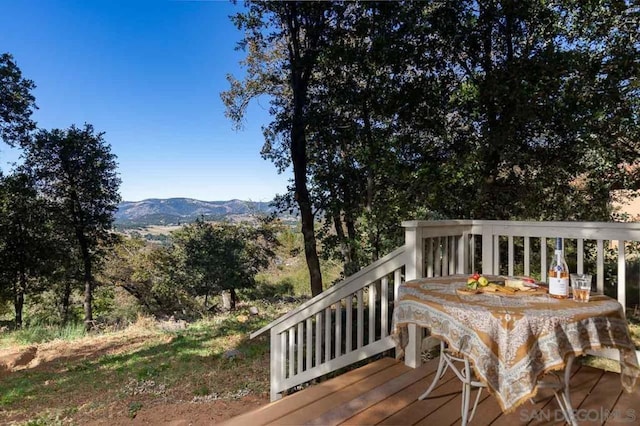 wooden deck with a mountain view