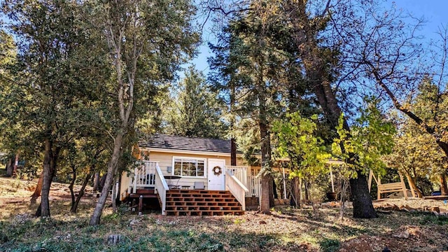 back of property featuring a wooden deck