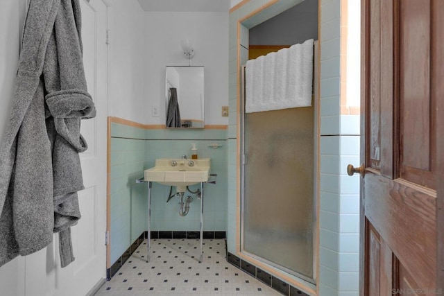 bathroom featuring a shower with shower door