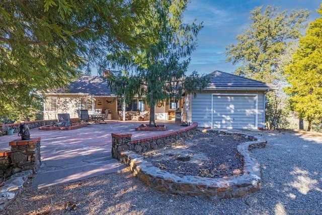 single story home with a patio area and a garage