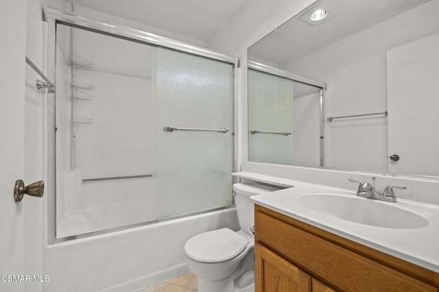 full bathroom featuring toilet, bath / shower combo with glass door, vanity, and tile patterned floors