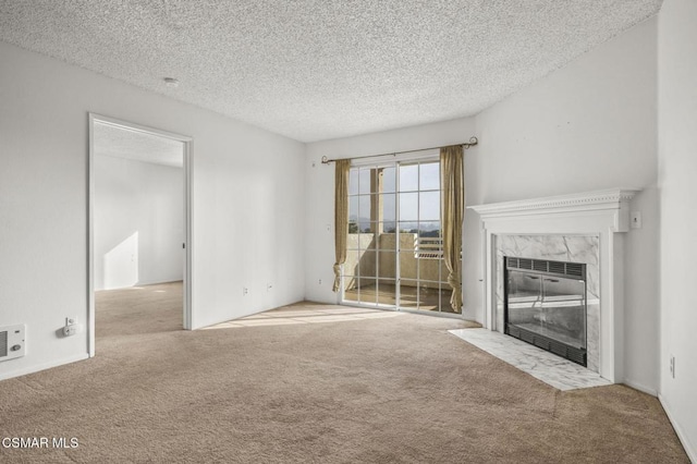 unfurnished living room with a textured ceiling, a high end fireplace, and light carpet