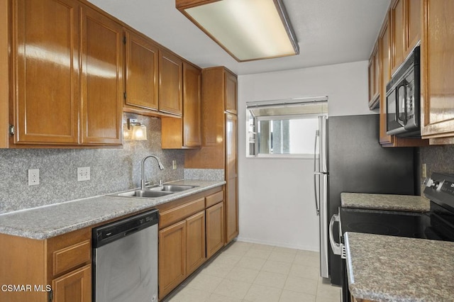 kitchen featuring sink, tasteful backsplash, and black appliances