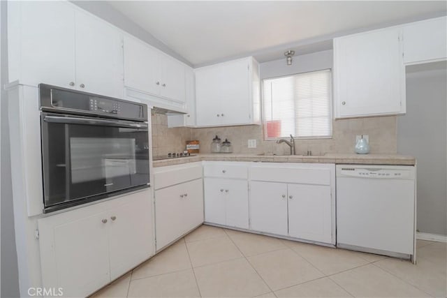 kitchen with black appliances, decorative backsplash, sink, and white cabinetry